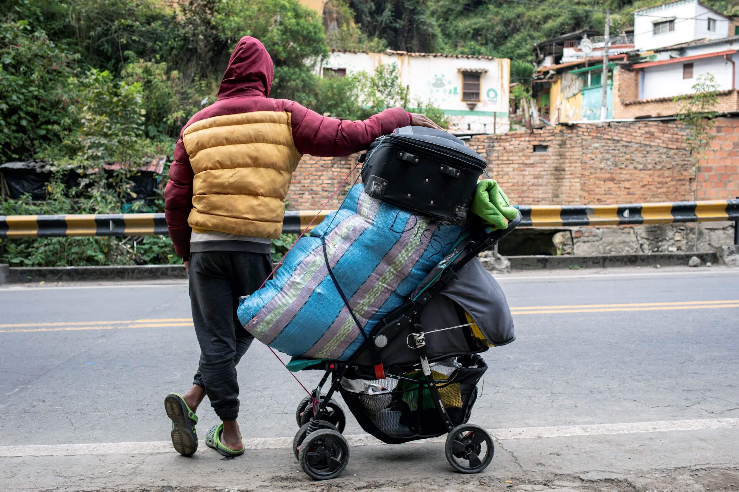 Photo credit: Colombia. Venezuelans prepare their luggage to continue their journey through the mountains. 2019 © UNHCR/Hélène Caux