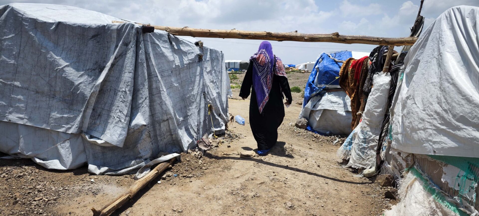 Yemen. A displaced woman walks to the AlSouda site for IDPs in AlDhalea. 2022 &copy; UNHCR/Ahmed Al-Mayadeen