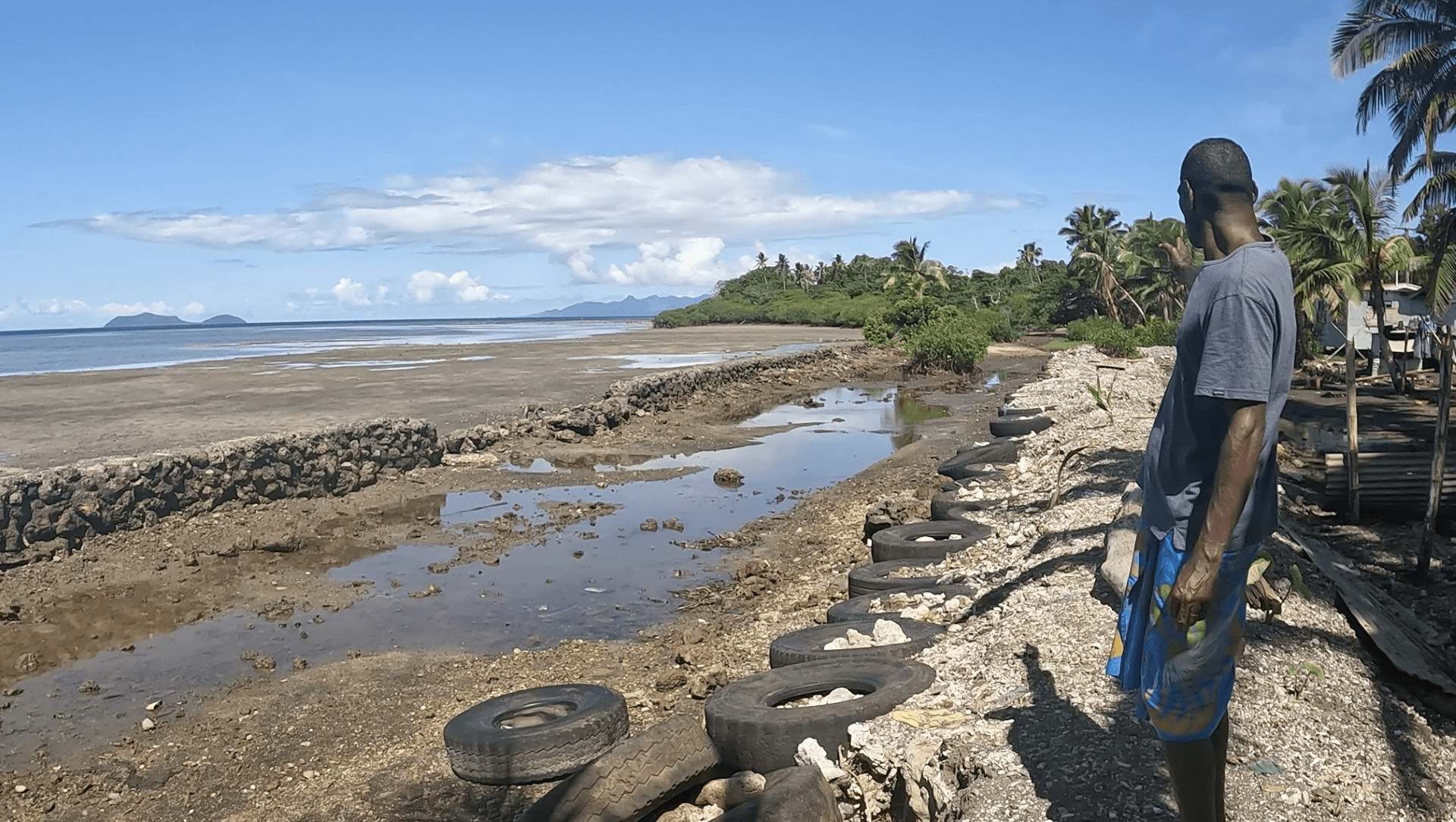 Fiji. Surveying damaged sea wall 2022 &copy; Brian Aycock