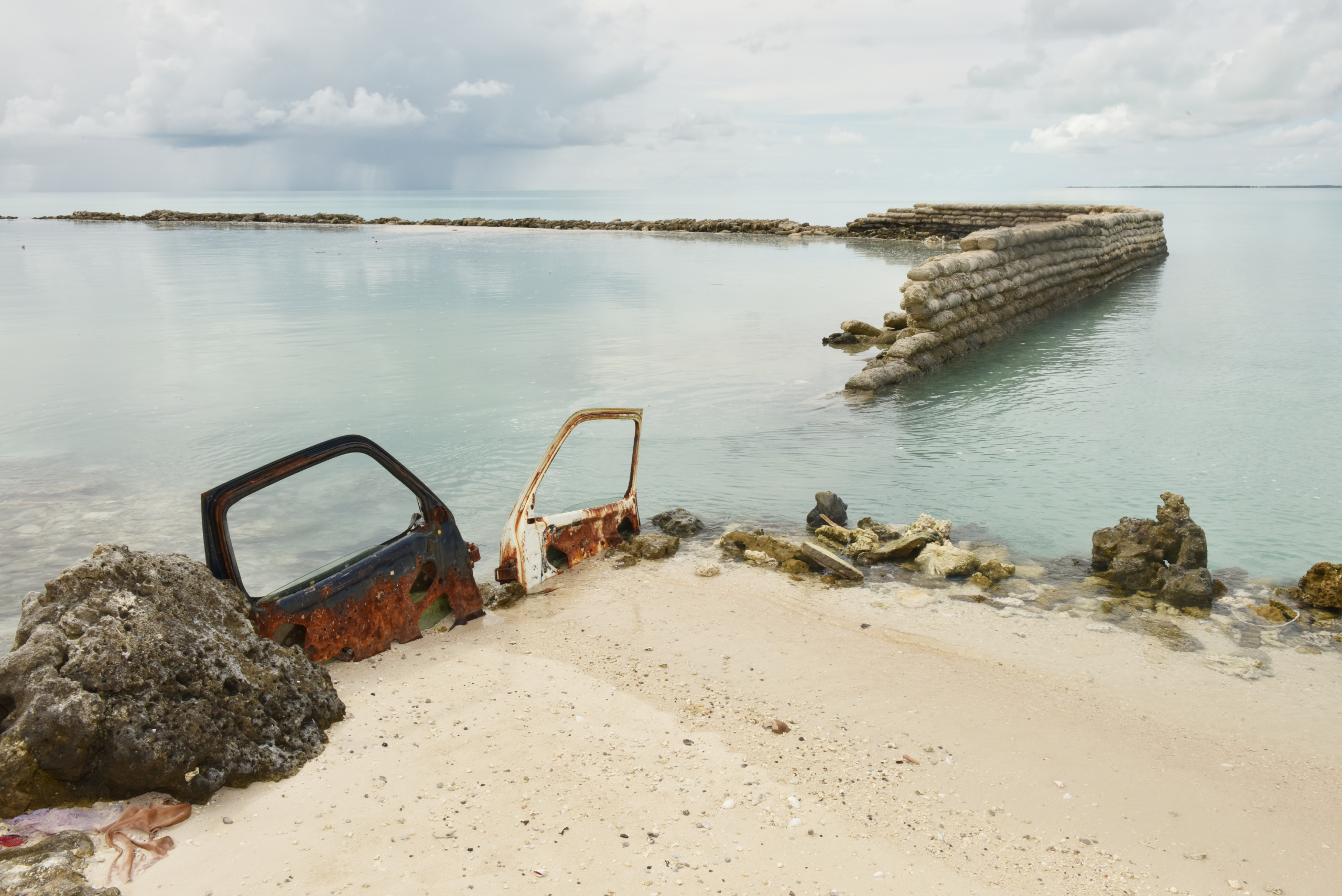 The picture of an area that has become uninhabitable and submerged due to coastal erosion was taken was taken by my wife Roswitha Meyer on Kiribati in 2013.